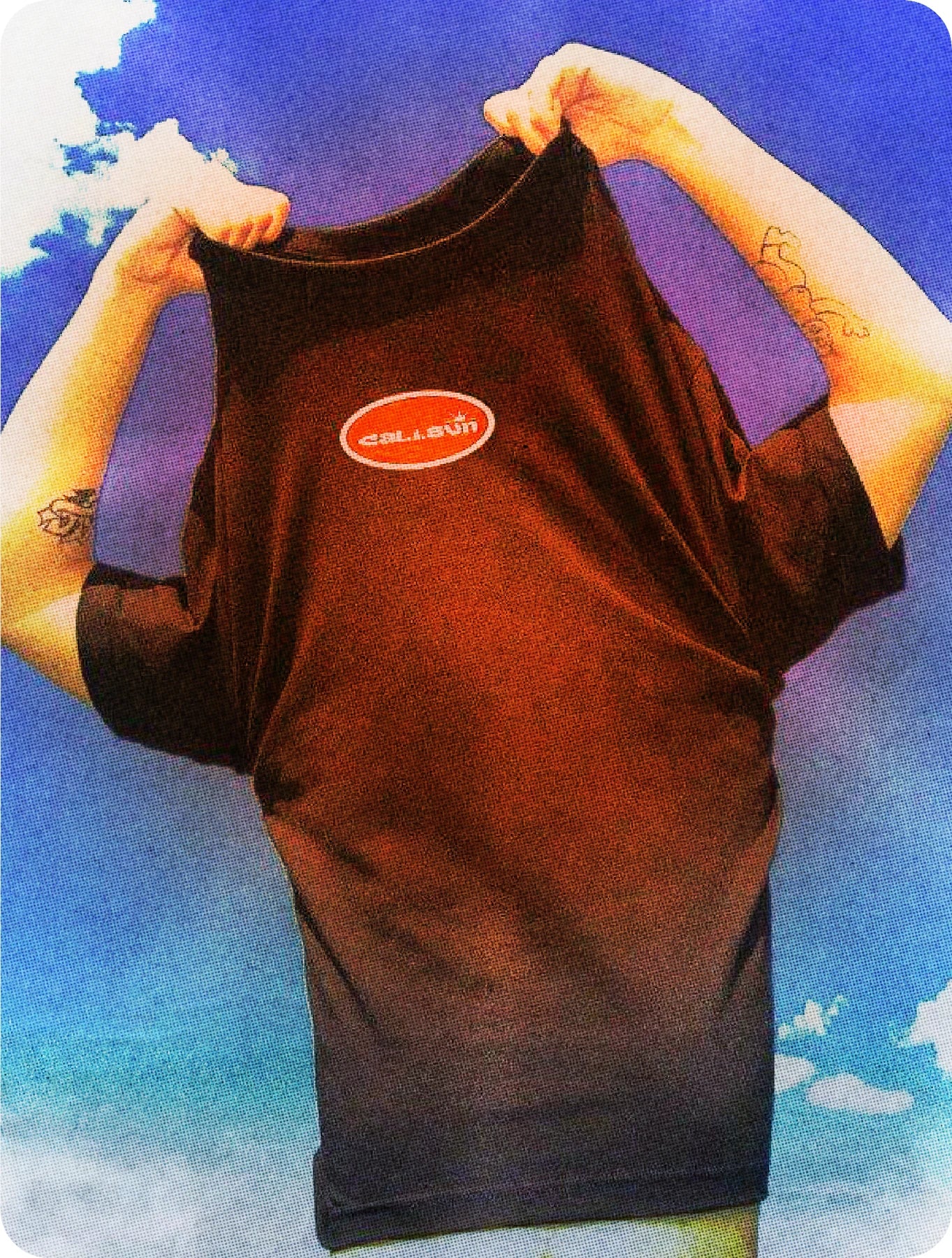 Person holding a Cali Sun wordmark shirt against a blue sky collage